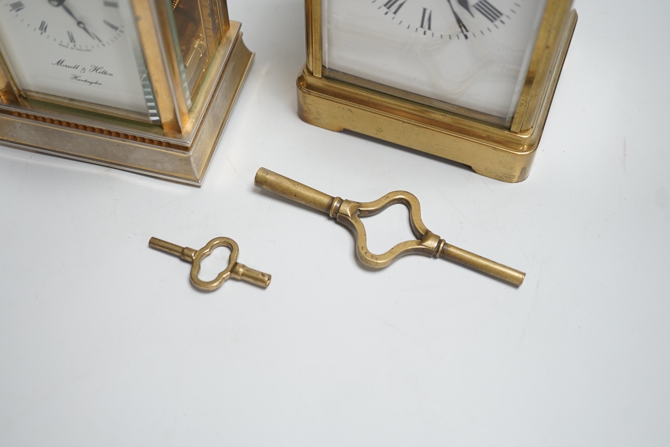 Two English brass carriage clocks with winding keys. Tallest 14.5cm